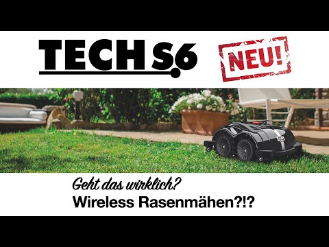 Das Bild zeigt den schwarzen Techline Mähroboter TECH S6, er steht auf einer Grünfläche "Wiese".